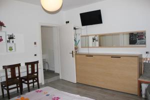 a kitchen with a cabinet and a tv on a wall at Casa Danilo in Cadegliano Viconago