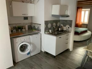 a kitchen with a washing machine and a sink at Casa Danilo in Cadegliano Viconago