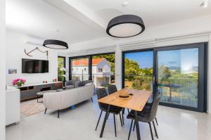 a kitchen and dining room with a table and chairs at Casa Bella in Lopud