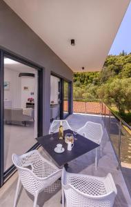 a dining room with a table and chairs on a patio at Casa Bella in Lopud