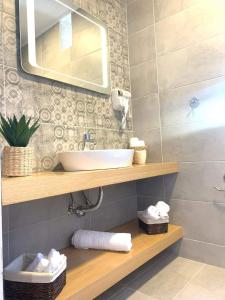 a bathroom with a sink and a mirror at Anemone traditional house in Lartos