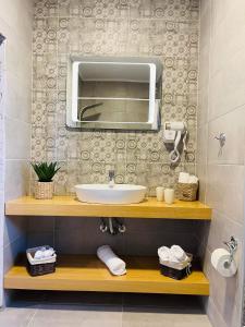 a bathroom with a sink and a mirror at Anemone traditional house in Lartos