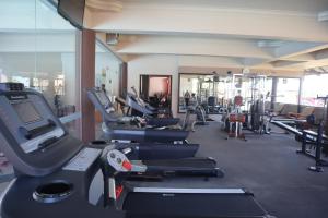 a gym with rows of treadmills and machines at Comforta Hotel Tanjung Pinang in Tanjung Pinang