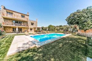 an estate with a swimming pool in a yard at Filia Stone Villa in Gouvia