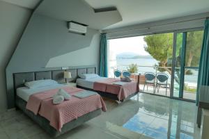 A bed or beds in a room at Oceanic Overview Suites