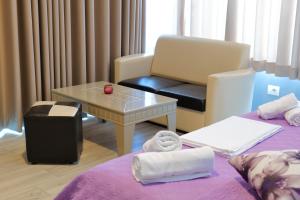A bed or beds in a room at Oceanic Overview Suites