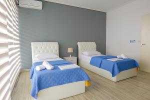 A bed or beds in a room at Oceanic Overview Suites