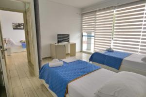 A bed or beds in a room at Oceanic Overview Suites