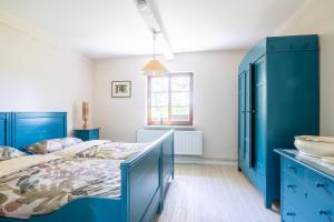 a blue bedroom with a bed and a sink at Landsitz Braderup Festland in Braderup +31 photos