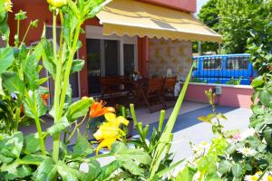 タソスにあるVilla Margaritaの花の咲く庭園とパティオのある家