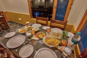 a table with plates of food on it at Baan by Snow City Farm in Manāli