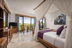 a bedroom with a bed and a living room at Swan Paradise A Pramana Experience in Gianyar