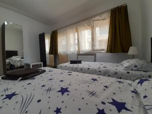 a bedroom with two beds with blue stars on them at Four Rooms Apartment Central in Bucharest
