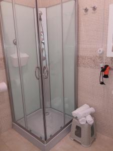 a shower with a glass door in a bathroom at Casa Narciso tra mare e canyon ad Avola in Avola +30 photos