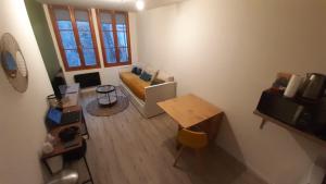 uma pequena sala de estar com um sofá e uma mesa em Studio 202 au 15 rue Battant à Besançon em Besançon
