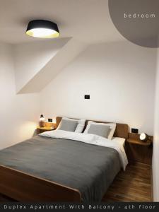 a bedroom with a large bed and a light at Piran Rooftop Apartments in Piran