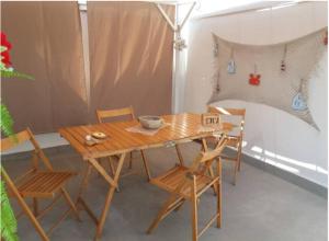 a wooden table and chairs in a room at Casa Narciso tra mare e canyon ad Avola in Avola