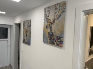 three paintings on a wall in a hallway at Ferienhaus Gmunden in Gmunden