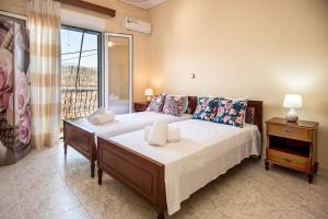 a bedroom with a large bed and a window at STEFANOS HOUSE in Argostoli