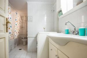 a white bathroom with a sink and a toilet at STEFANOS HOUSE in Argostoli +16 photos