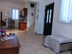 a living room with a table with two glasses of wine at Comfy Alykes Apartment, Volos in Volos