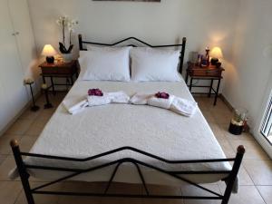 a bedroom with a bed with two towels on it at Comfy Alykes Apartment, Volos in Volos