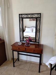 a dressing table with a mirror on top of it at Comfy Alykes Apartment, Volos in Volos