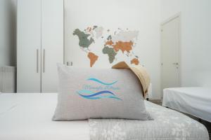 a pillow on a bed with a world map at Meraviglia d'Otranto in Otranto