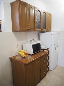 a kitchen with a microwave and bananas on a counter at Holiday home TONČICA - Rogotin in Rogotin