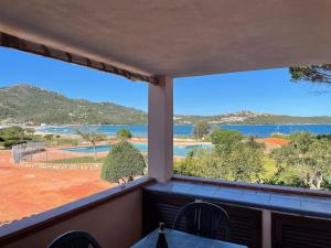 a balcony with a view of a body of water at Sardegna Beach Cala Reale in Santa Marinella