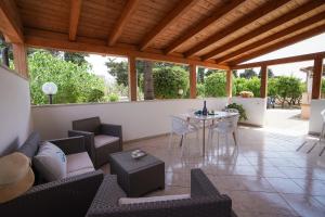 a covered patio with a table and chairs at Meraviglia d'Otranto in Otranto