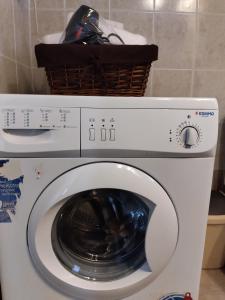 a washing machine with a basket on top of it at Comfy Alykes Apartment, Volos in Volos