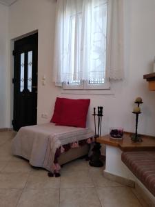 a bedroom with a bed with a red pillow on it at Comfy Alykes Apartment, Volos in Volos
