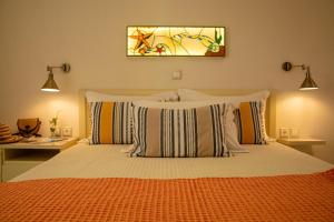 a bedroom with a bed with pillows and a window at Aristea Studios in Sarti