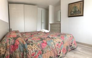 a bedroom with a bed with a colorful quilt at Sardegna Beach Cala Reale in Santa Marinella