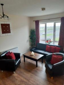 a living room with two couches and a coffee table at Kilkee Bay Apartments in Kilkee