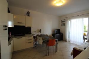 a kitchen with a table and a dining room at Villaggio Sant'Andrea in Caorle