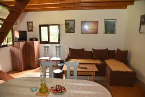 a living room with a couch and a table at Vikendica na Sokolini in Gornja Koprivna