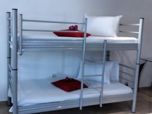 a bunk bed room with two bunk beds and a table at Comfy Alykes Apartment, Volos in Volos