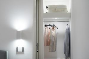 a room with a closet with dresses and a lamp at Meraviglia d'Otranto in Otranto