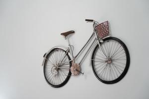 a bike with a basket hanging on a wall at Meraviglia d'Otranto in Otranto
