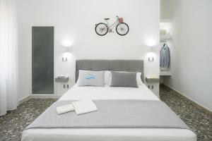 a bedroom with a bed with a bicycle on the wall at Meraviglia d'Otranto in Otranto