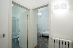 a bathroom with a toilet and a bedroom with a bed at Meraviglia d'Otranto in Otranto