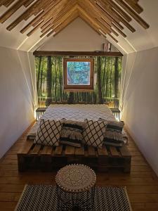 a large bed in a room with a window at Cityside Cottage in Eger