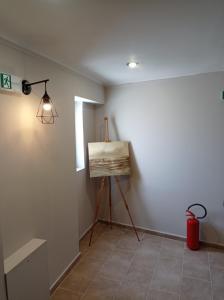 a painting on a tripod in a room with a light at Elaėa Boutique Apartments in Piraeus