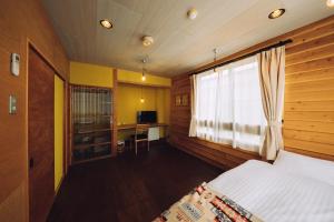 una camera con letto, finestra e scrivania di Noasobi Lodge 204- Vacation STAY 23357v ad Arao