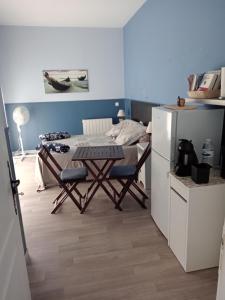 a kitchen with a table and a bed in a room at chez lulu in Saint-Saturnin-les-Apt