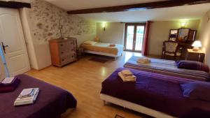 a bedroom with two beds and a dresser in it at Gites PassionPastel in Pech-Luna +28 photos