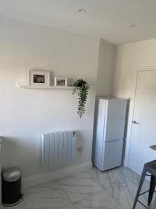 a kitchen with a white refrigerator in a room at Bridlington Shore Apartment in Bridlington