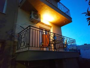 a balcony of a building with a light on it at Comfy Alykes Apartment, Volos in Volos
